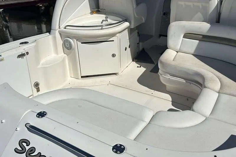 Slide: The Image of 2006 Sea Ray 340 Sundancer boat interior with white seating and compact sink area. - 6