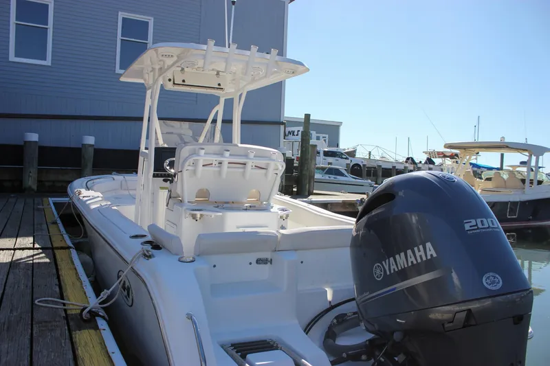 Slide: The Image of 2020 Sea Hunt Ultra 234 boat with Yamaha engine in indoor setting. - 10