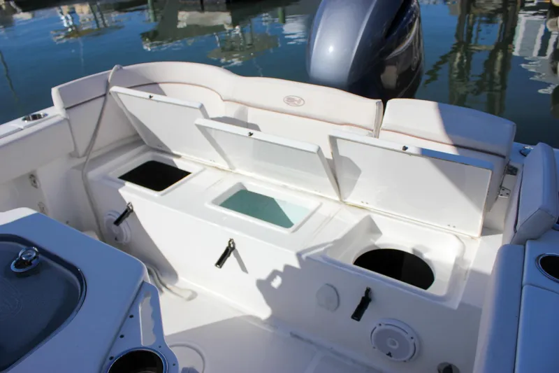 Slide: The Image of 2020 Sea Hunt Ultra 234 boat interior with cushioned seating and Yamaha 200 engine. - 11