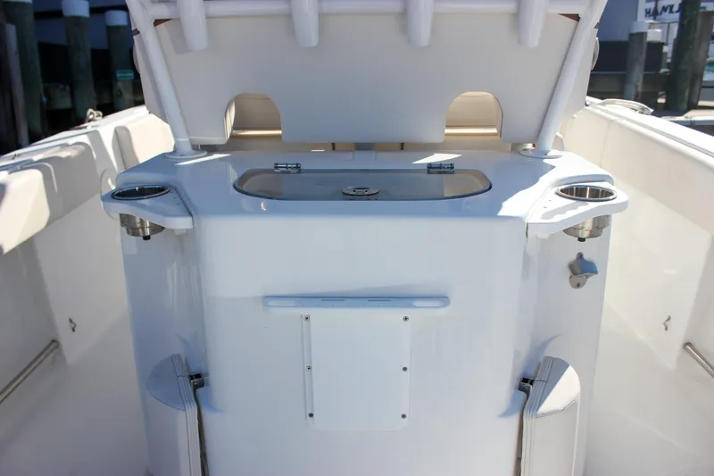 Slide: The Image of 2020 Sea Hunt Ultra 234 boat interior with cushioned seating and built-in speakers. - 12