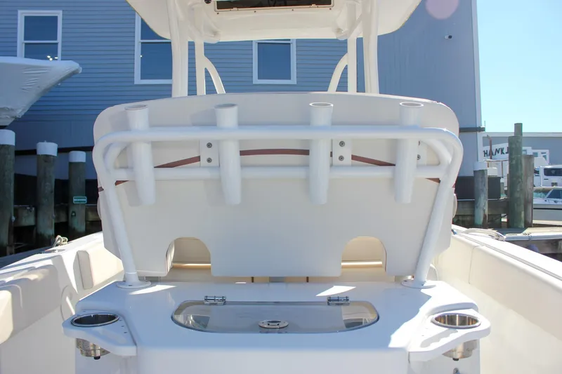 Slide: The Image of 2020 Sea Hunt Ultra 234 boat interior with storage compartments and cup holders. - 13