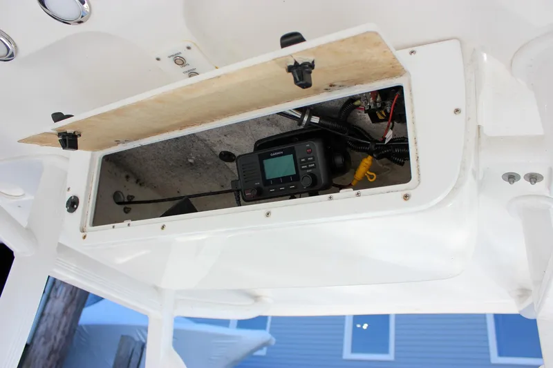 Slide: The Image of Livewell compartment in 2020 Sea Hunt Ultra 234 boat, featuring a clean interior. - 14