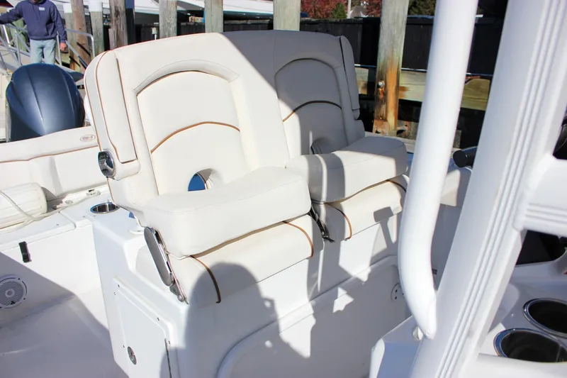 Slide: The Image of Storage compartment on a 2020 Sea Hunt Ultra 234 boat with organized drawers and tackle boxes. - 17