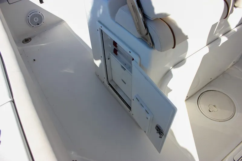 Slide: The Image of 2020 Sea Hunt Ultra 234 boat seat with rod holders, indoor display. - 18