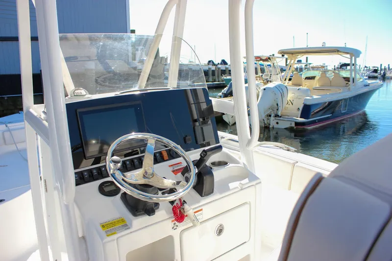 Slide: The Image of 2020 Sea Hunt Ultra 234 boat console with Garmin navigation system and steering wheel. - 20