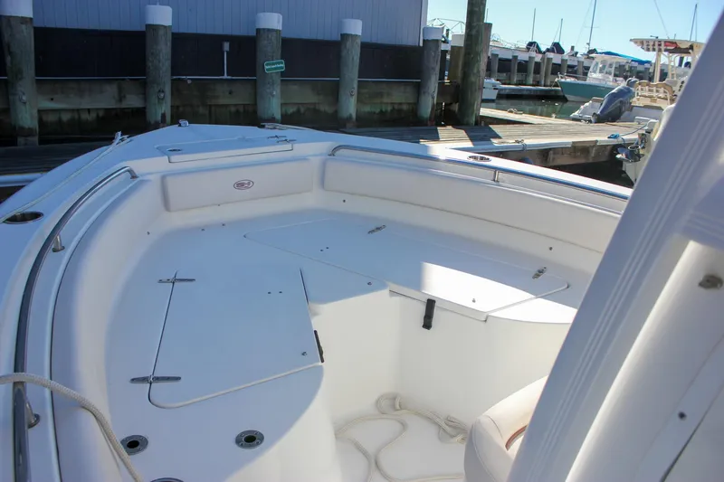 Slide: The Image of 2020 Sea Hunt Ultra 234 boat electronics compartment with Garmin device and wiring. - 26