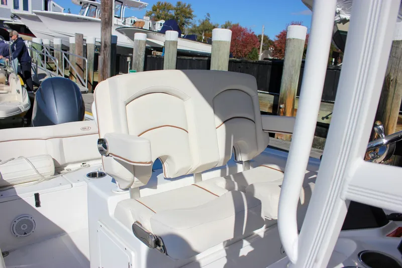 Slide: The Image of 2020 Sea Hunt Ultra 234 boat interior with portable toilet in storage compartment. - 28