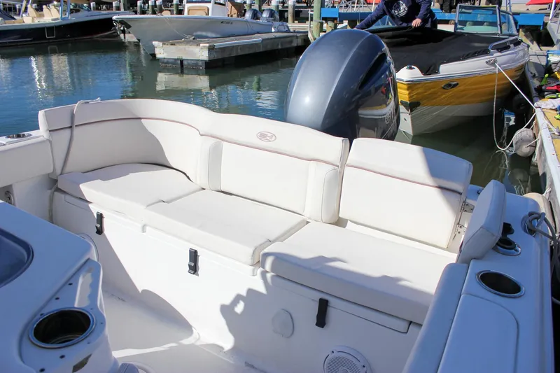 Slide: The Image of 2020 Sea Hunt Ultra 234 boat interior with white cushioned seating. - 31