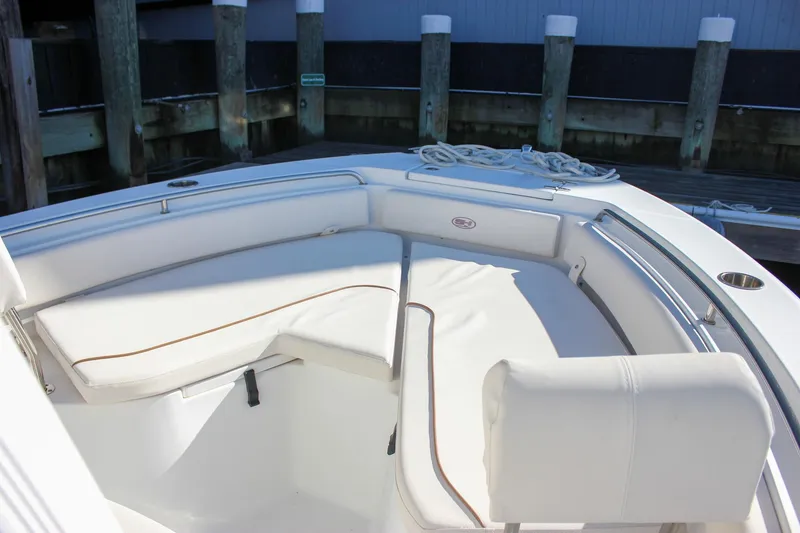 Slide: The Image of 2020 Sea Hunt Ultra 234 boat interior with white seating and console. - 33