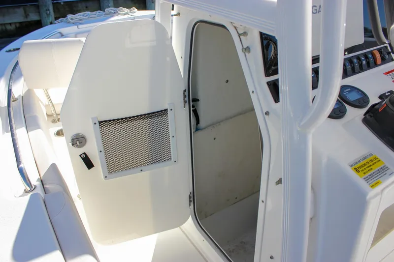 Slide: The Image of Livewell compartment on a 2020 Sea Hunt Ultra 234 boat, featuring a clean white interior. - 35