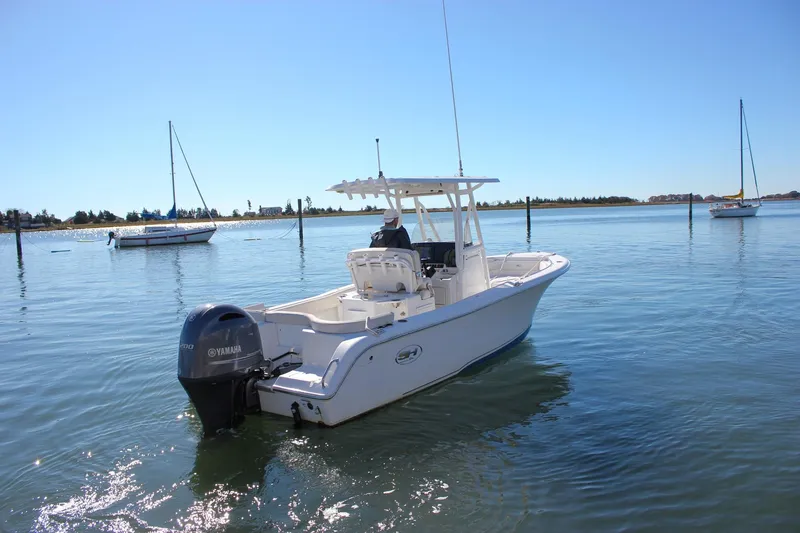 Slide: The Image of 2020 Sea Hunt Ultra 234 boat interior with storage compartments and seating. - 37