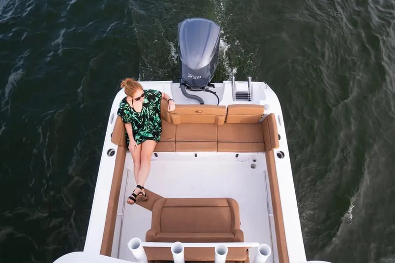 Slide: The Image of 2020 Sea Hunt Ultra 234 boat interior with white cushioned seating. - 44