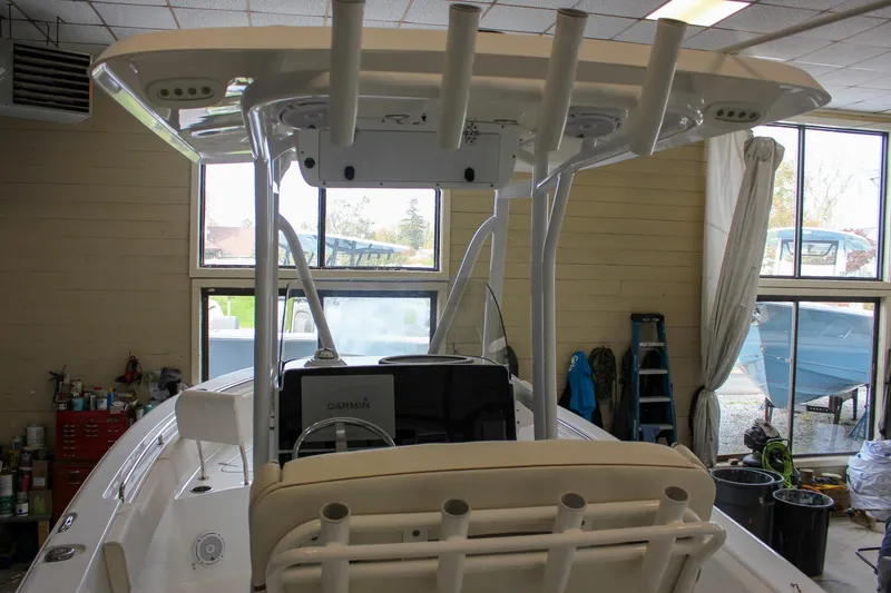Slide: The Image of 2020 Sea Hunt Ultra 234 boat interior with T-top and Garmin electronics in a workshop. - 47