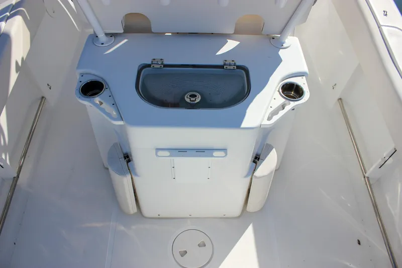 Slide: The Image of 2020 Sea Hunt Ultra 234 boat interior with storage compartment and cup holders. - 5