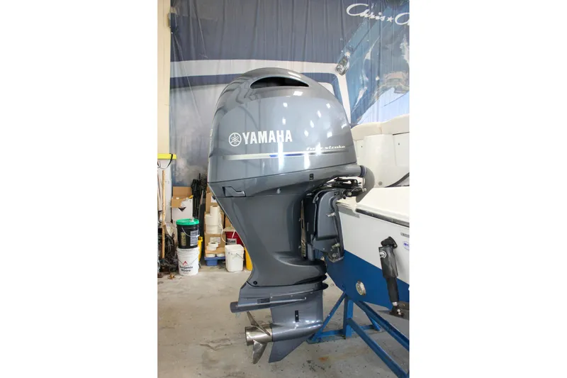 Slide: The Image of 2020 Sea Hunt Ultra 234 with Yamaha outboard motor in a garage setting. - 51