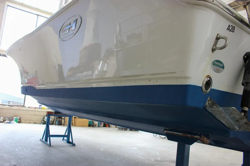 Slide: The Image of 2020 Sea Hunt Ultra 234 boat on stands in a workshop. - 56