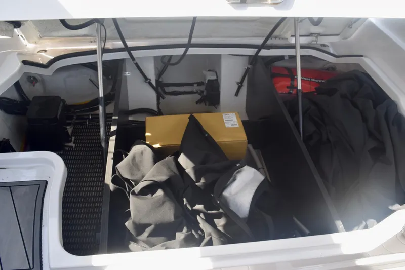 Slide: The Image of Storage compartment of 2025 Monterey 275SS Super Sport boat with various items inside. - 103