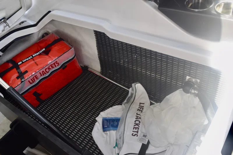 Slide: The Image of Storage compartment with life jackets on a 2025 Monterey 275SS Super Sport boat. - 104