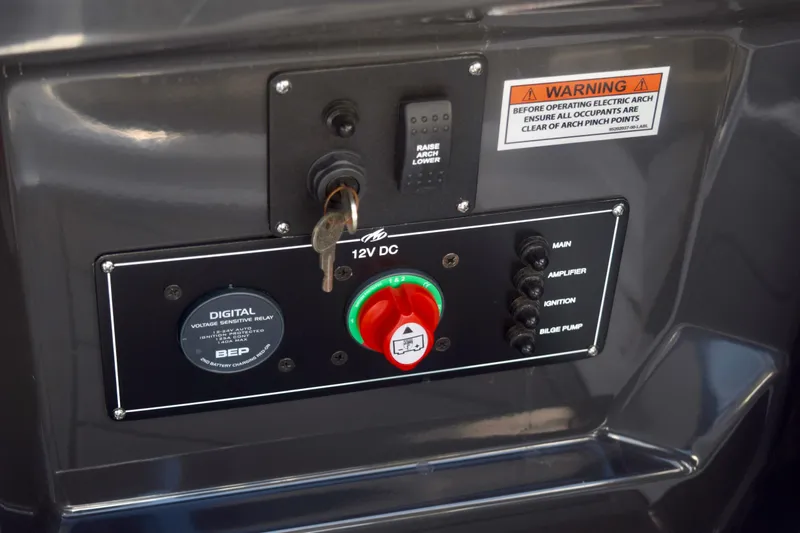 Slide: The Image of Control panel of 2025 Monterey 275SS Super Sport boat with key and warning label. - 106