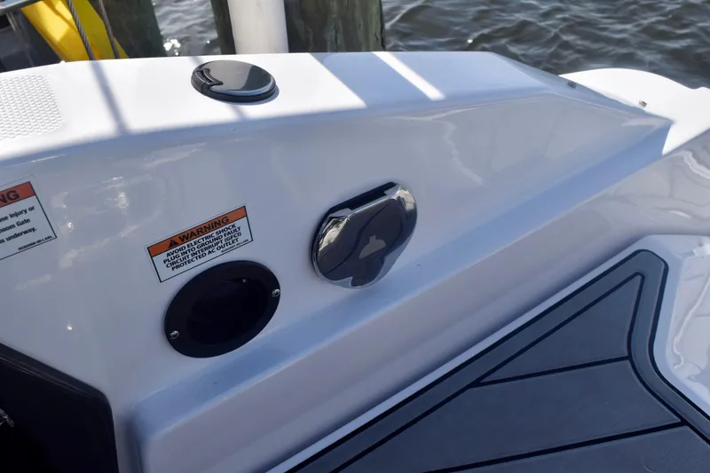 Slide: The Image of 2025 Monterey 275SS Super Sport boat deck with warning labels and fittings. - 112