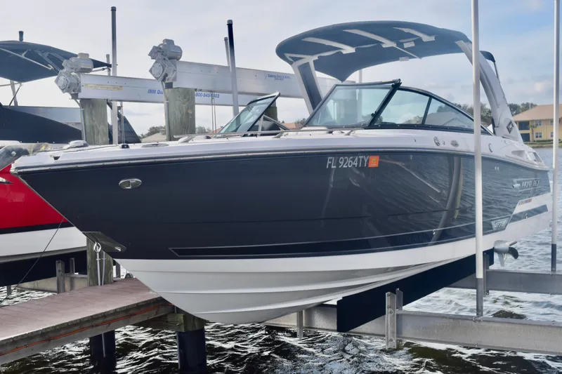 Slide: The Image of 2025 Monterey 275SS Super Sport boat docked on a lift, side view. - 2