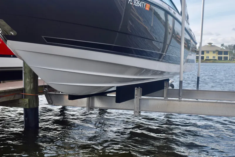 Slide: The Image of 2025 Monterey 275SS Super Sport boat on lift by waterfront. - 21