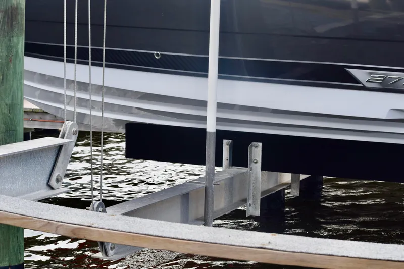 Slide: The Image of 2025 Monterey 275SS Super Sport boat on a lift at a dock. - 30