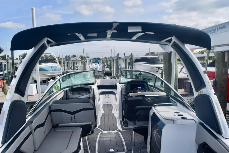 Slide: The Image of 2025 Monterey 275SS Super Sport boat interior at marina, featuring sleek seating and modern design. - 36