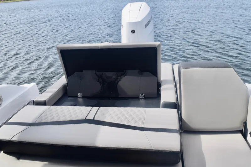 Slide: The Image of 2025 Monterey 275SS Super Sport boat with open storage compartment on water. - 41