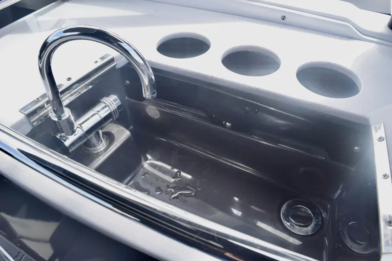 Slide: The Image of 2025 Monterey 275SS Super Sport boat sink with chrome faucet and cup holders. - 55