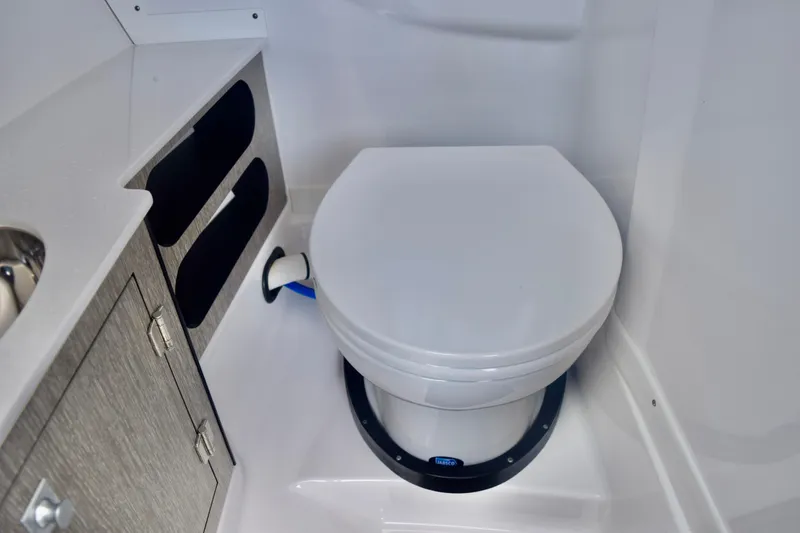 Slide: The Image of 2025 Monterey 275SS Super Sport boat bathroom with modern toilet and storage cabinets. - 63