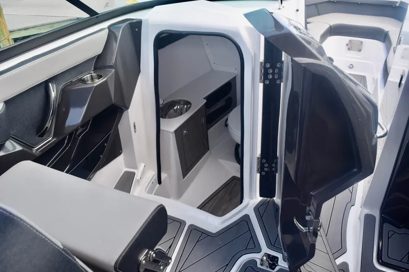 Slide: The Image of 2025 Monterey 275SS Super Sport boat interior with open cabin door and seating area. - 65