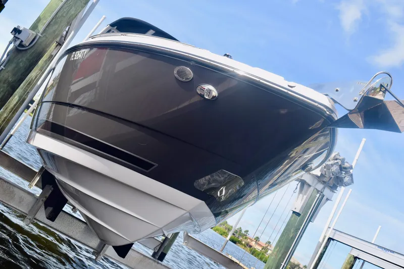 Slide: The Image of 2025 Monterey 275SS Super Sport boat on lift, docked by the water. - 8