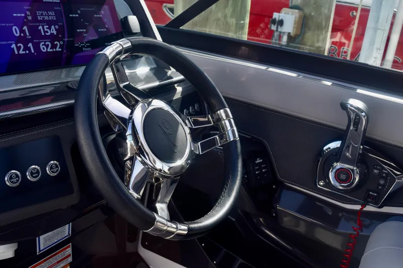 Slide: The Image of 2025 Monterey 275SS Super Sport boat dashboard with steering wheel and control panel. - 82