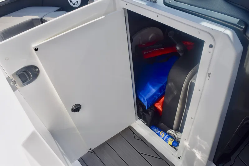 Slide: The Image of Storage compartment on 2025 Monterey 275SS Super Sport boat with safety gear and supplies. - 98