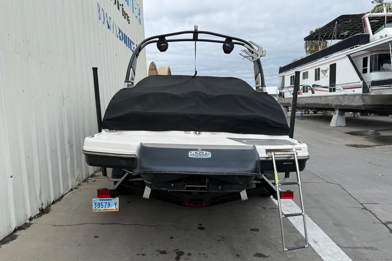 Slide: The Image of 2018 Chaparral Vortex 2430 VRX boat, rear view with cover and ladder, docked. - 10