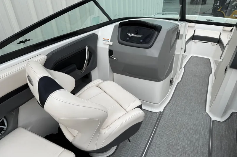 Slide: The Image of 2018 Chaparral Vortex 2430 VRX boat interior with white seating and modern dashboard. - 14