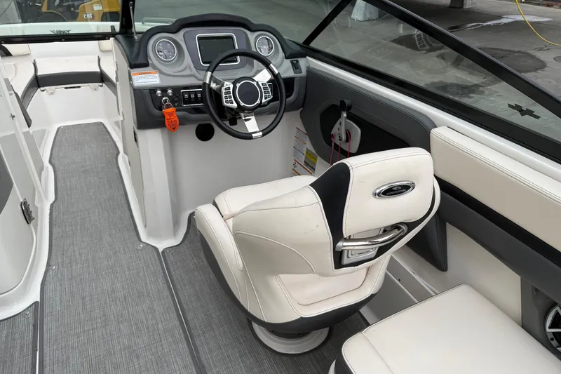 Slide: The Image of 2018 Chaparral Vortex 2430 VRX boat interior with steering wheel and seating. - 15