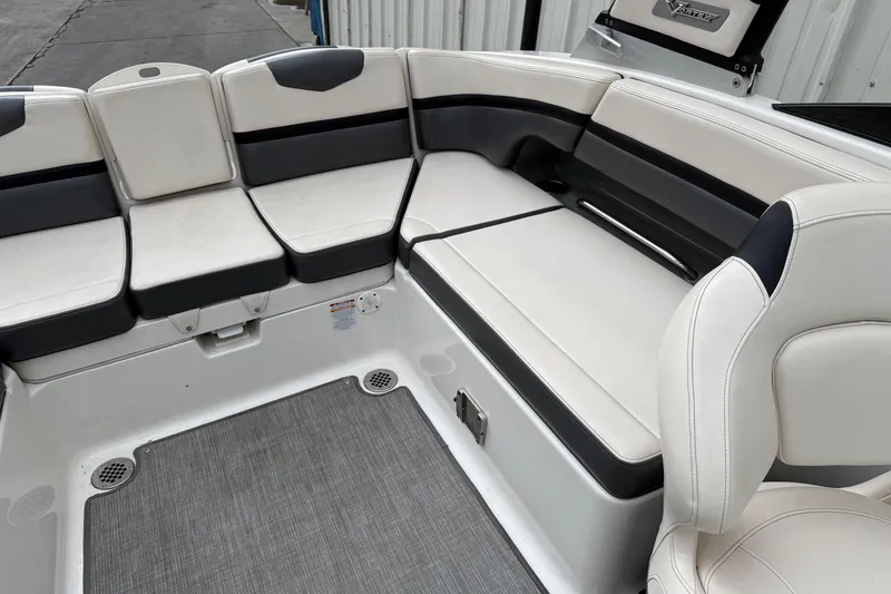 Slide: The Image of 2018 Chaparral Vortex 2430 VRX boat interior with white and black seating. - 17