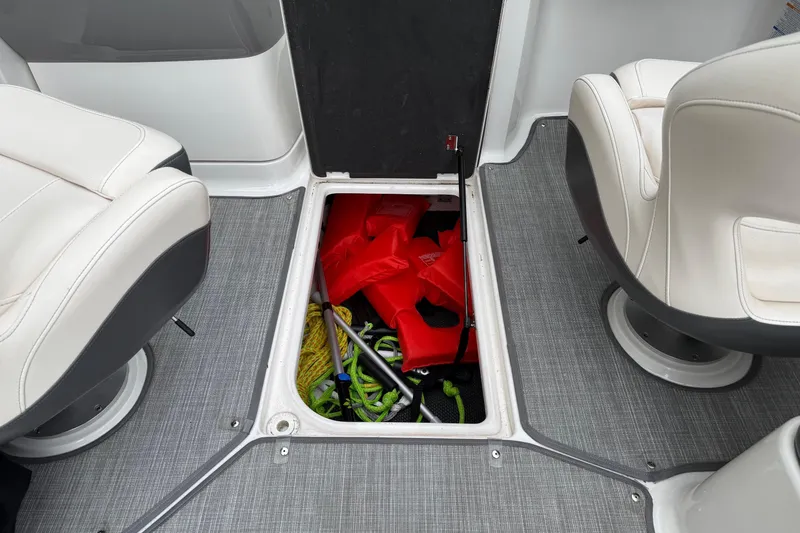 Slide: The Image of 2018 Chaparral Vortex 2430 VRX boat storage compartment with life jackets and equipment. - 19