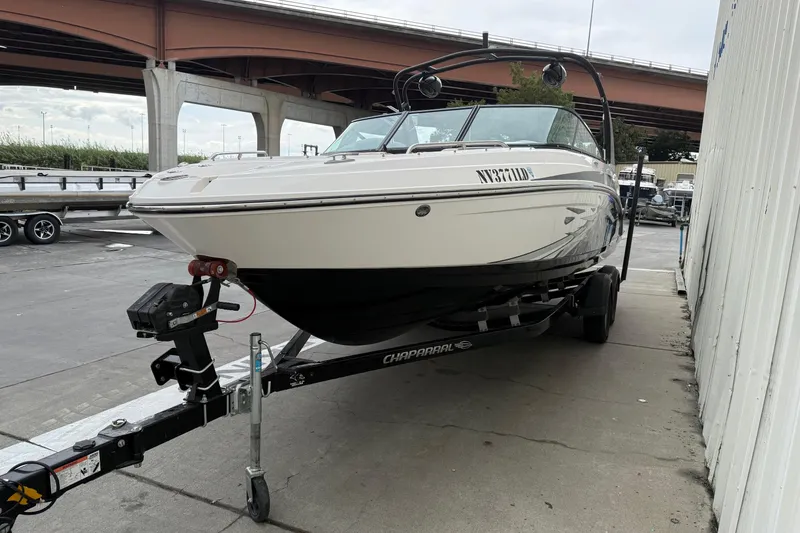Slide: The Image of 2018 Chaparral Vortex 2430 VRX boat on trailer, parked near an overpass. - 3
