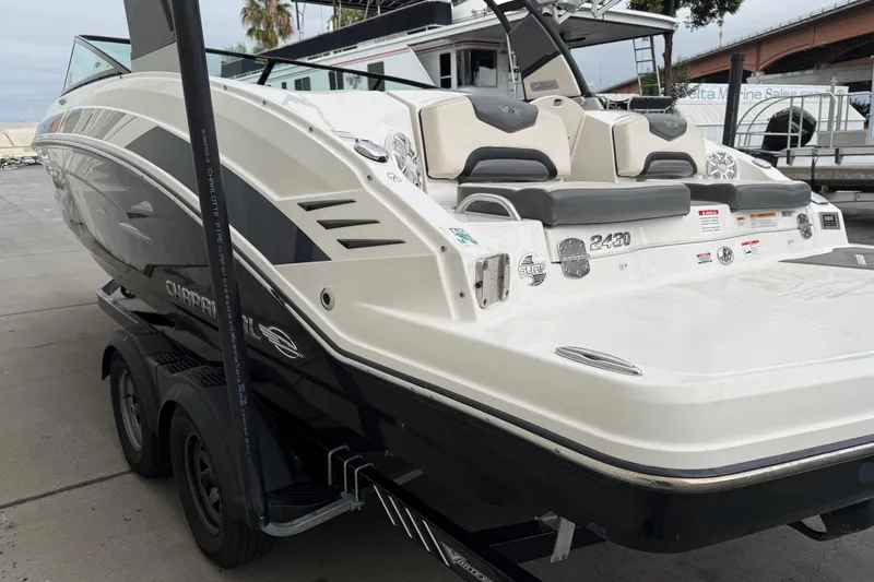 Slide: The Image of 2018 Chaparral Vortex 2430 VRX boat on trailer, rear view, dockside setting. - 4