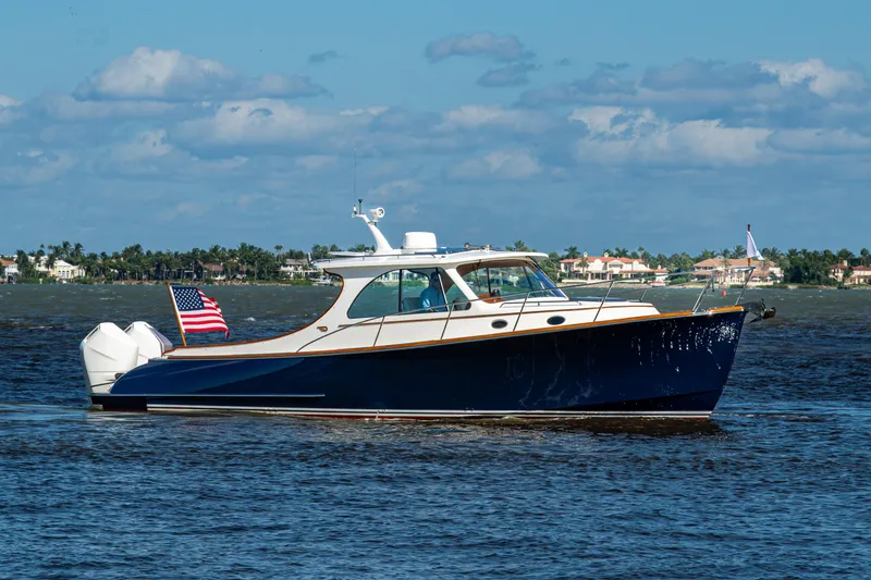 Slide: The Image of 2024 Hinckley 35 boat cruising on a sunny day with American flag. - 14