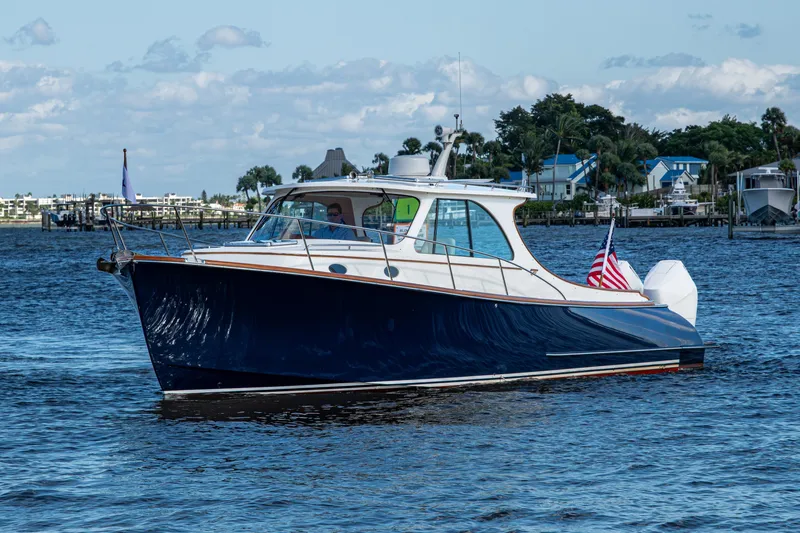 Slide: The Image of 2024 Hinckley 35 boat cruising on a sunny day with American flag. - 16
