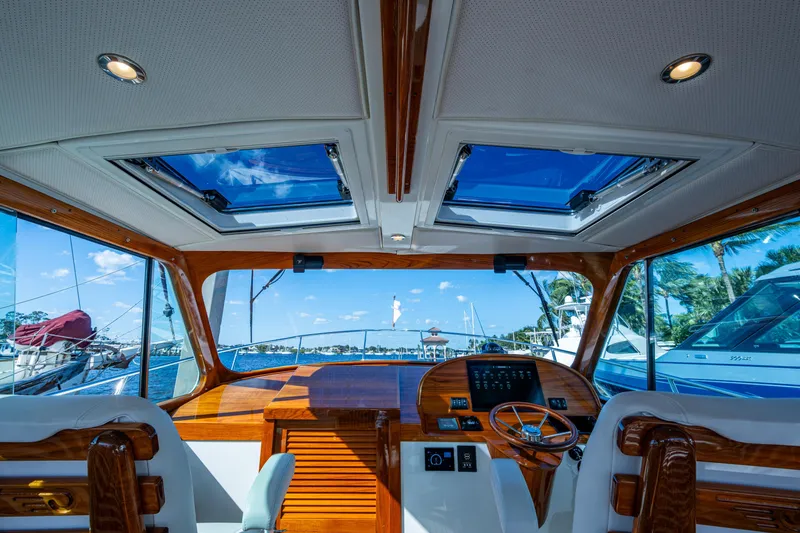 Slide: The Image of Interior view of 2024 Hinckley 35 yacht cockpit with wooden accents and skylights. - 2