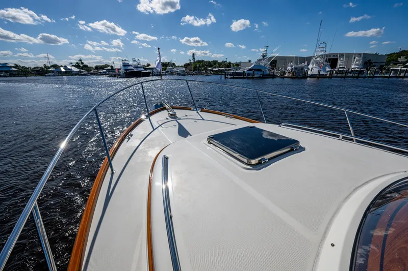 Slide: The Image of 2024 Hinckley 35 yacht deck view at marina under blue sky. - 22