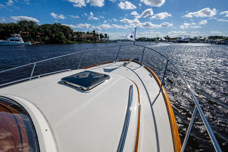 Slide: The Image of 2024 Hinckley 35 yacht cruising on a sunny day with scenic waterfront views. - 24