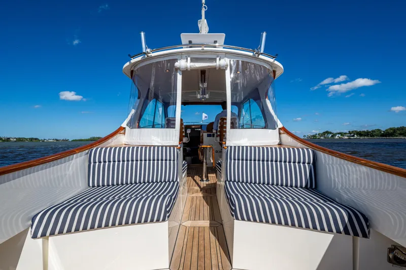 Slide: The Image of 2024 Hinckley 35 yacht with striped seating, cruising on a sunny day. - 31