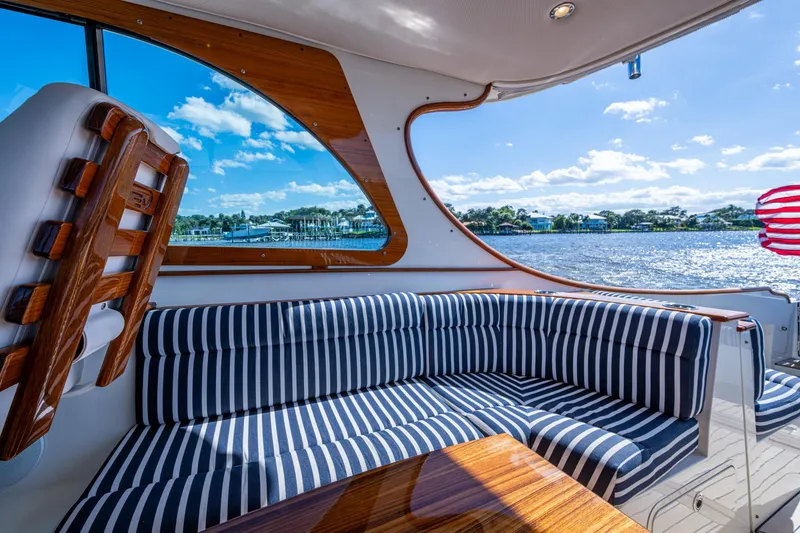 Slide: The Image of Luxurious interior of 2024 Hinckley 35 yacht with striped seating and scenic water view. - 33