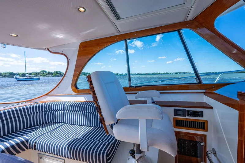 Slide: The Image of Interior of 2024 Hinckley 35 yacht with striped seating and scenic water view. - 36